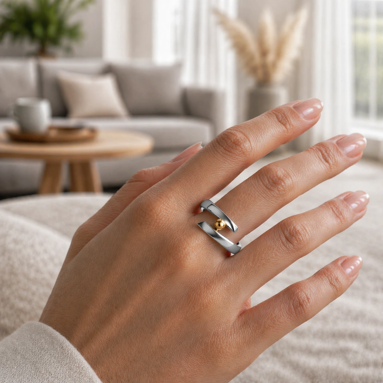 minimalism ring with a gold detail worn on hand in minimalist scandinavian interior