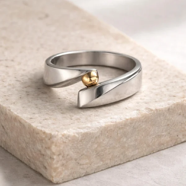 scandinavian minimalism ring with a smaall golden ball. the ring is inspired by form, structure and scandinavian interior